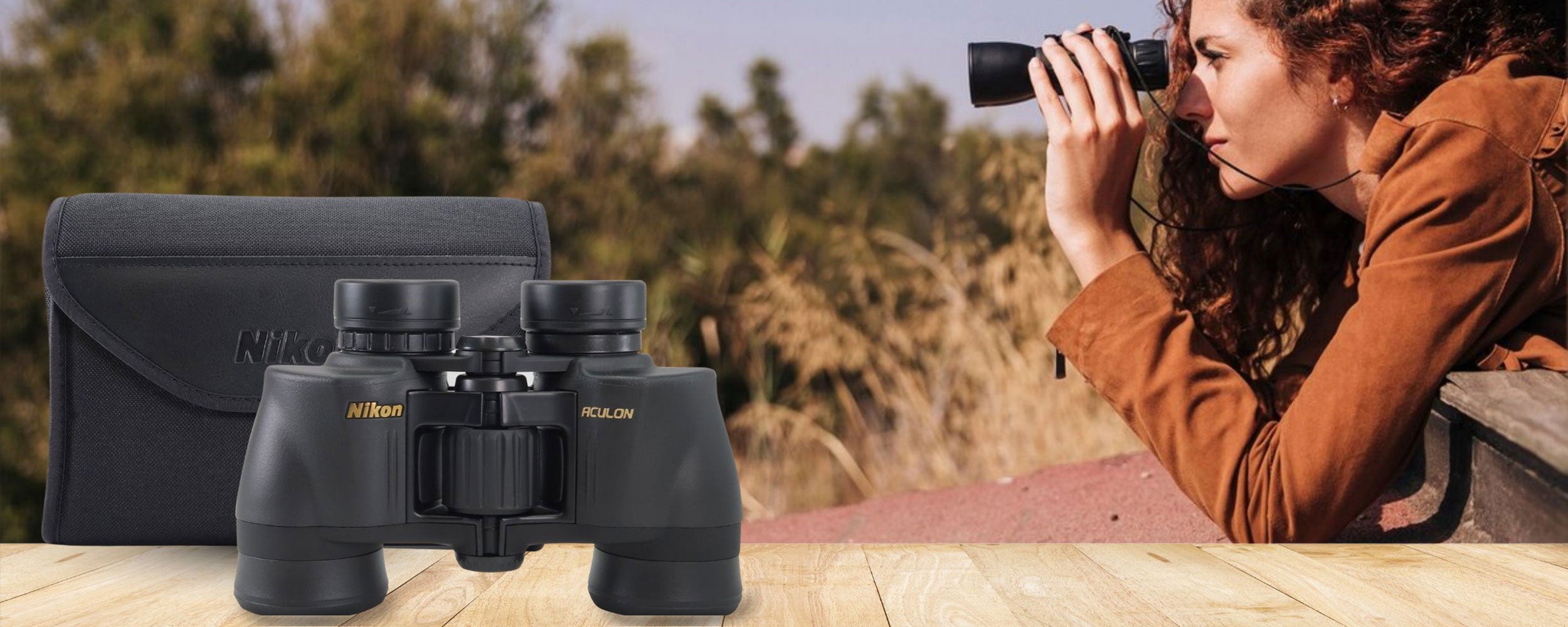 Banner for binoculars, showing a pair of binoculars and someone enjoying outdoor views through them.