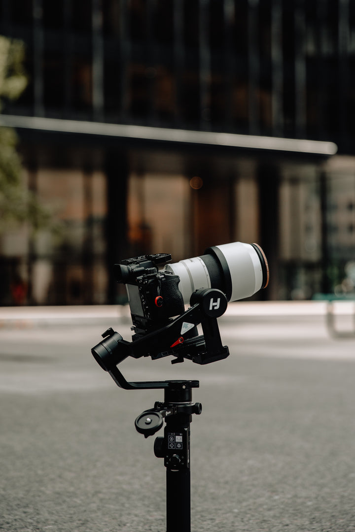 A camera with a long lens is prominently displayed, suggesting high-quality photography equipment. The banner promotes photography Collection.