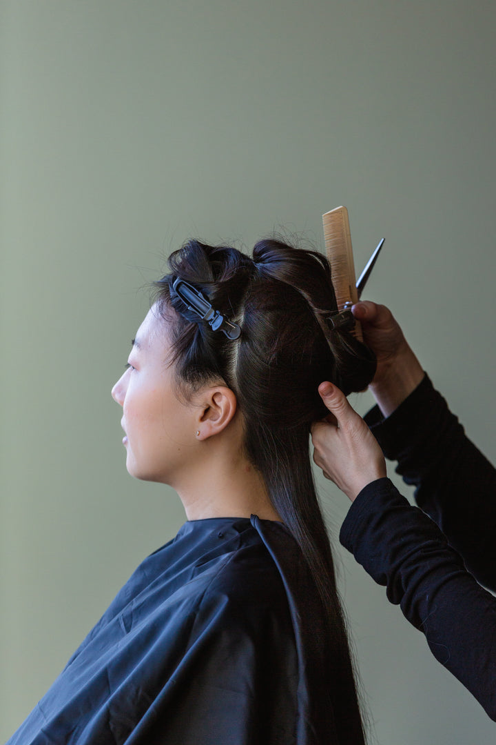 A women is getting hair styled, showcasing health and beauty products. The banner promotes health and beauty tools.